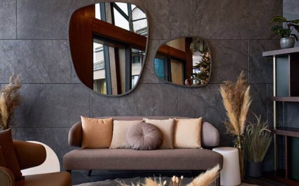 a couch and mirror on a wall