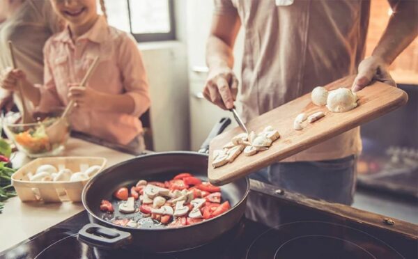 a man and a girl cooking