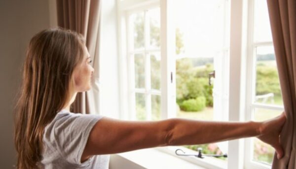 a woman opening a window