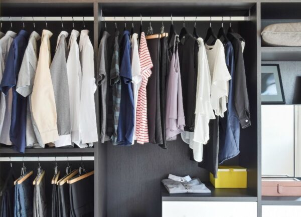 a closet with clothes on swingers