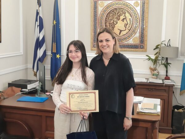 two women holding a certificate