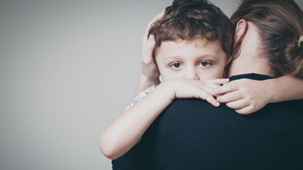 a child hugging a woman