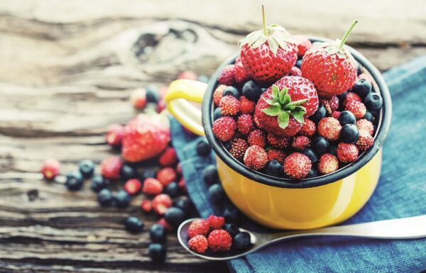 a yellow mug full of berries