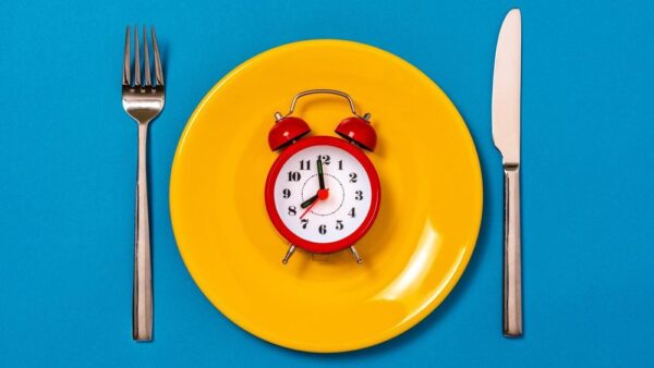 a plate with a clock on it and a fork and knife
