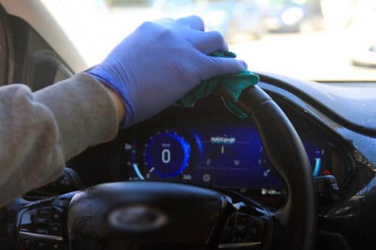 a person cleaning a car steering wheel