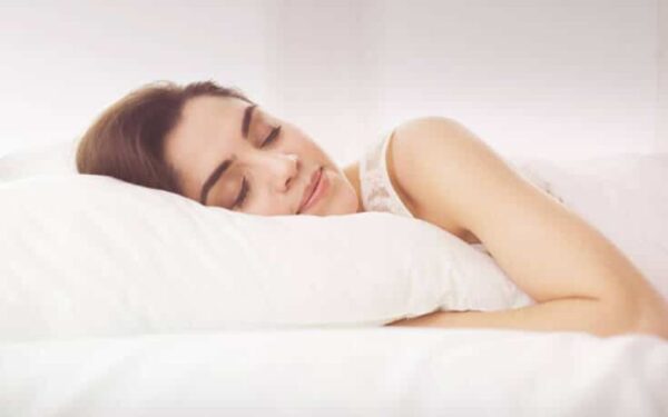 a woman sleeping on a pillow