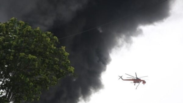 a helicopter flying over a tree
